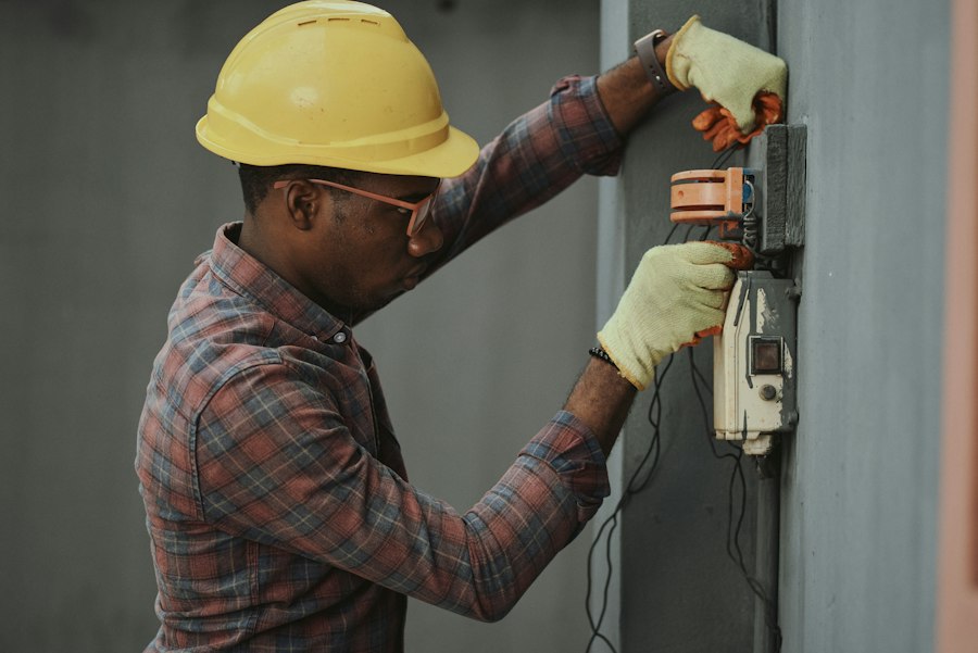 Technician installing a fiber optic connection box