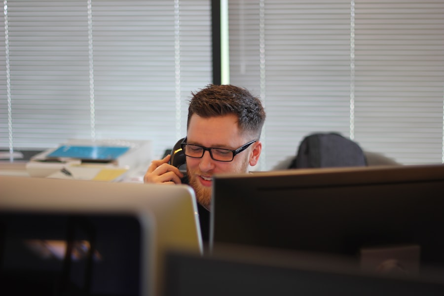 Employee using a business desk phone in an office