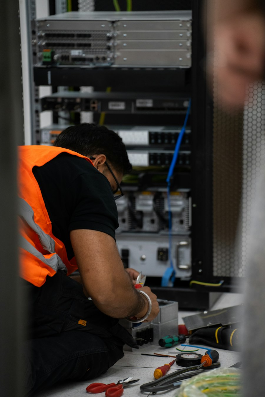 Technician organizing structured cabling in a server rack