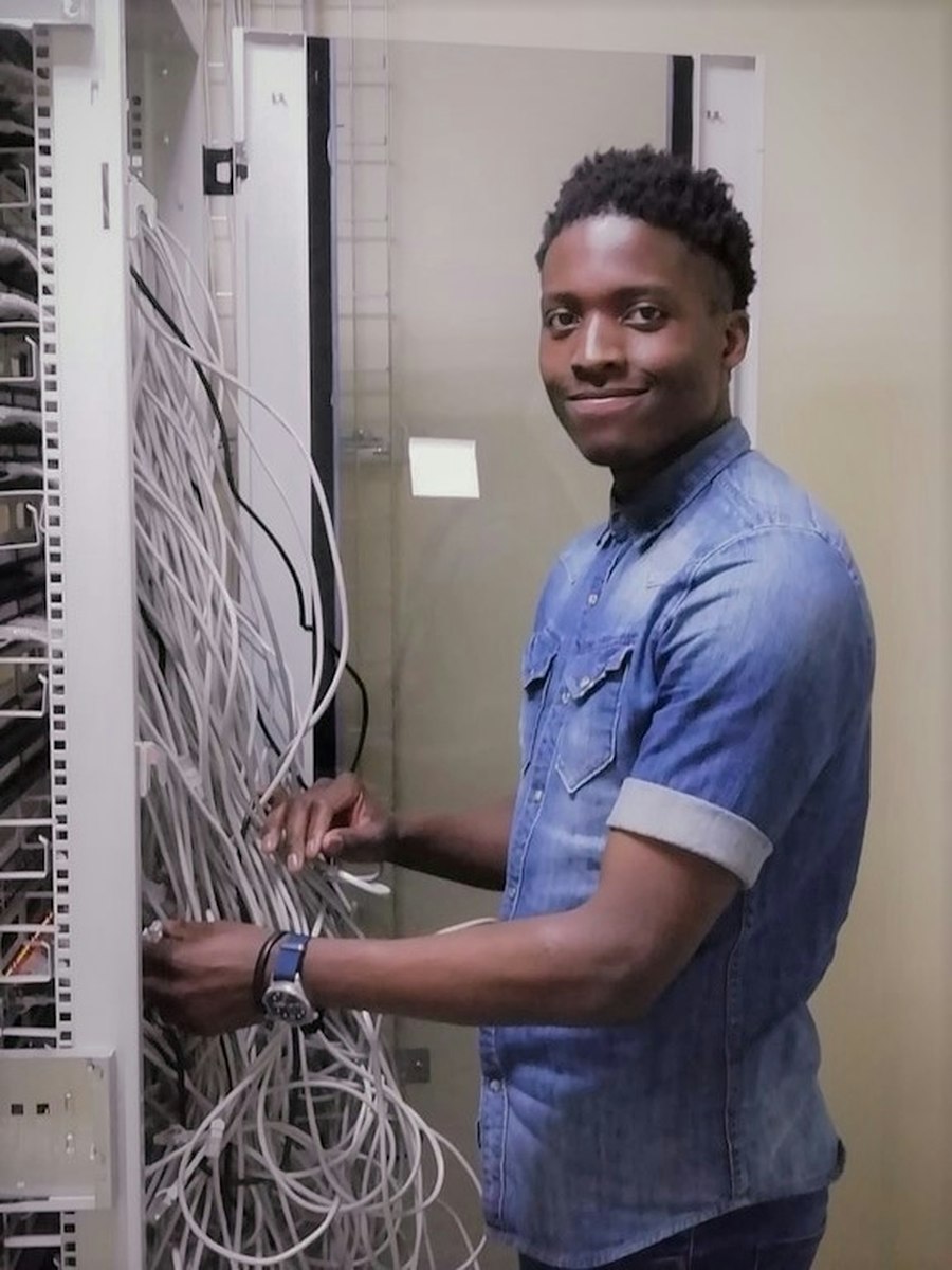 Technician setting up network wiring for WiFi coverage